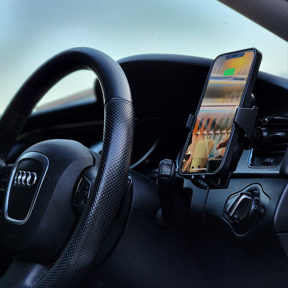 An Urban Auto15 Universal Wireless Car Charger Kit with a cell phone holder in the dashboard.